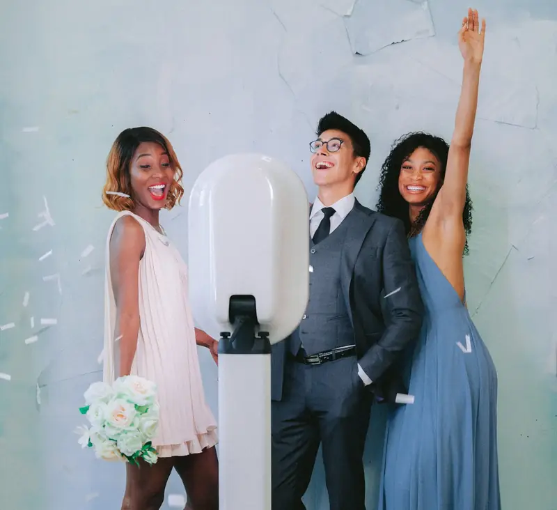 Wedding guests cheering at a photo booth rental in NYC