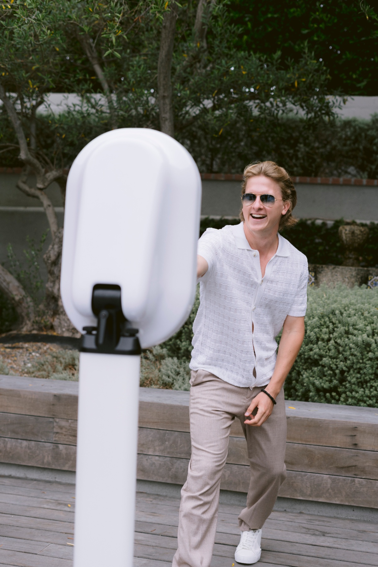 Guest laughing at a photo booth rental at an outdoor event in New Jersey